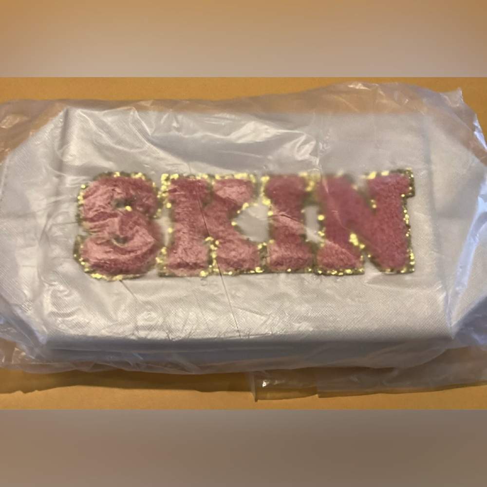 NWT- TWO white cosmetic bags with “SKIN” and “HAIR” in Pink and Gold Lettering